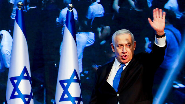 Benjamin Netanyahu greets supporters in Tel Aviv on election night