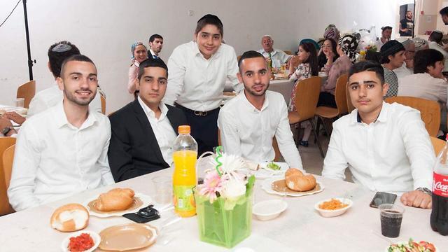 Asher Hazut, center, with family members