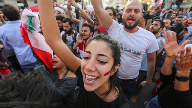 Lebanese protesters celebrate in Beirut at news of PM Saad Hariri's resignation (צילום: רויטרס) Lebanese protesters celebrate in Beirut at news of PM Saad Hariri's resignation