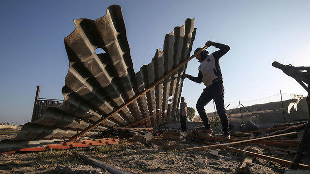 Gazans inspect the damage caused by Israeli strikes overnight