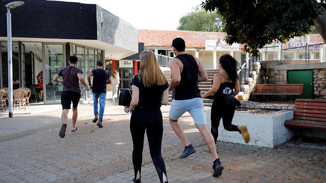 Israelis in Ashkelon run for a bomb shelter during a rocket attack from Gaza 