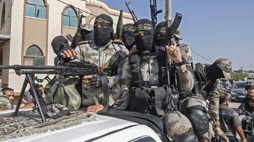 Palestinian Islamic Jihad terrorists attend the funeral of a fellow fighter in Khan Younis in the southern Gaza Strip 