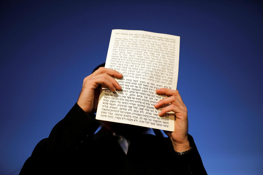 A Jewish worshipper performs the Tashlich ceremony, whereby Jews symbolically cast away their sins ahead of Yom Kippur 