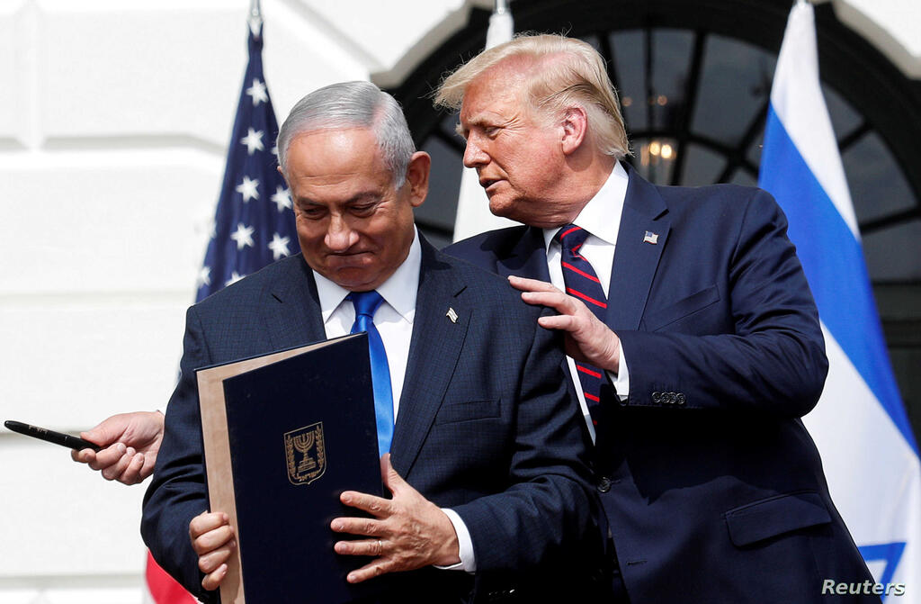Prime Minister Benjamin Netanyahu stands with US President Donald Trump after signing the Abraham Accords, at the White House 