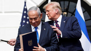 Prime Minister Benjamin Netanyahu stands with US President Donald Trump after signing the Abraham Accords, at the White House 