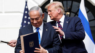 Prime Minister Benjamin Netanyahu stands with US President Donald Trump after signing the Abraham Accords, at the White House 