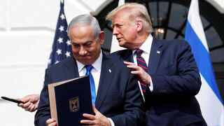 Prime Minister Benjamin Netanyahu stands with US President Donald Trump after signing the Abraham Accords, at the White House 
