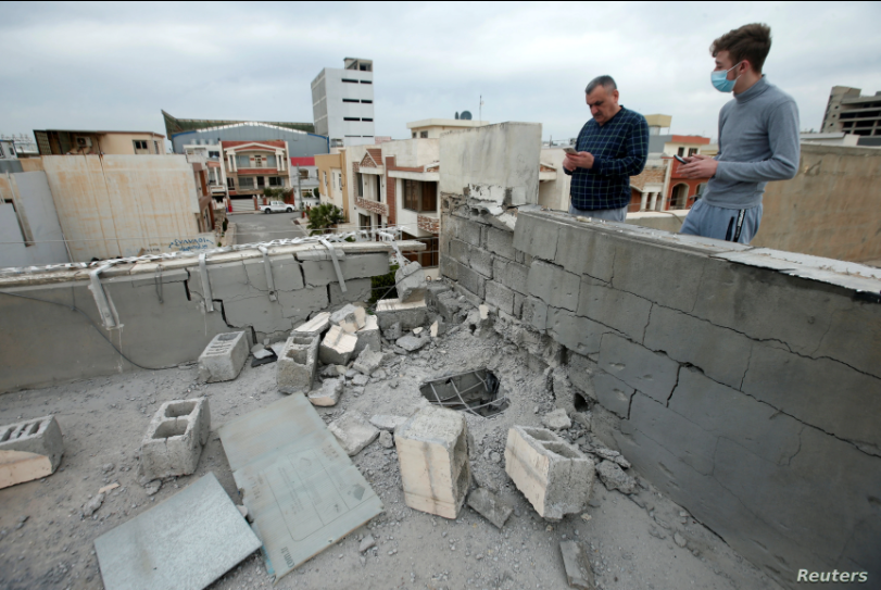 People stand next to a damaged roof after a rocket attack on U.S.-led forces in and near Irbil International Airport in Irbil, Iraq, Feb. 16, 2021 (Photo: Reuters) People stand next to a damaged roof after a rocket attack on U.S.-led forces in and near Irbil International Airport in Irbil, Iraq, Feb. 16, 2021