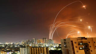 Streaks of light are seen as Israel's Iron Dome anti-missile system intercept rockets launched from the Gaza Strip towards Israel, as seen from Ashkelon, 