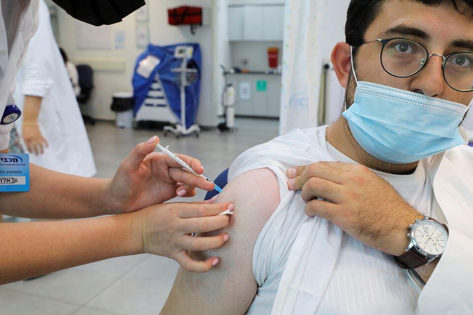 An Israeli man receives his third dose of the coronavirus disease (COVID-19) vaccine, in Beit Shemesh 
