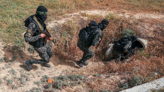 Members of the Palestinian Islamic Jihad militant group enter a tunnel in the Gaza Strip, during a media tour amid escalating tensions with Israel