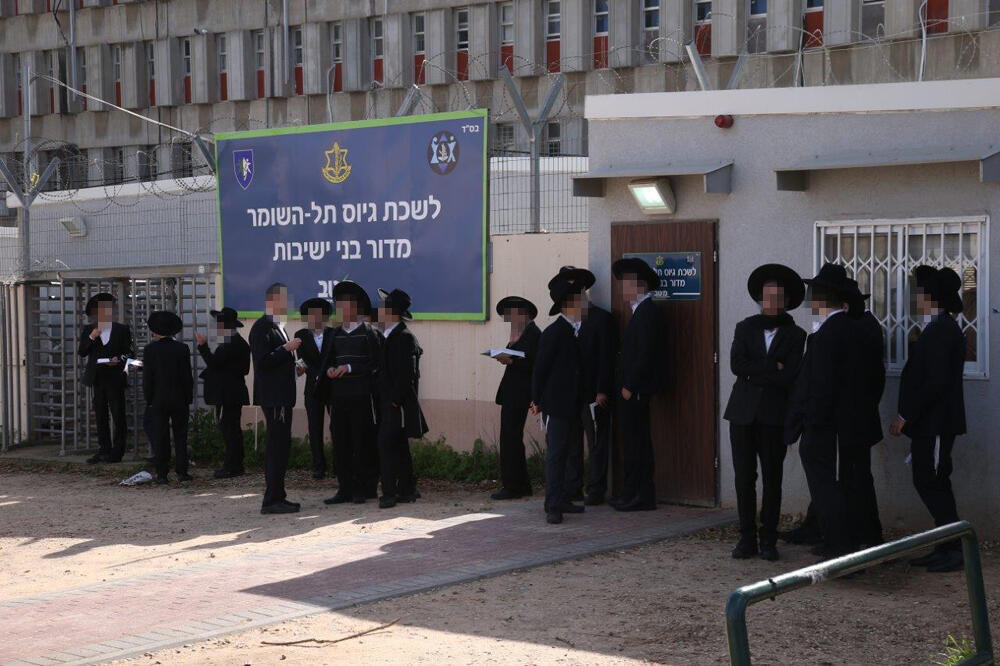 Ultra-Orthodox men outside an IDF recruitment office 
