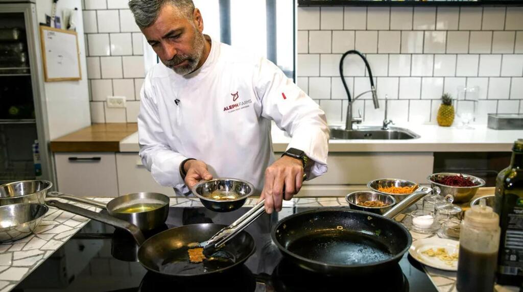Chef Amir Ilan prepares a lab-grown steak during a presentation by the Israeli company Aleph Farms, in Jaffa, Israel