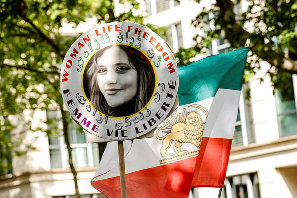 A demonstrator carries the portrait of Mahsa Amini, who died in detention following her arrest by the Iranian morality police in September 2022 (Photo: Teresa Suarez) A demonstrator carries the portrait of Mahsa Amini, who died in detention following her arrest by the Iranian morality police in September 2022