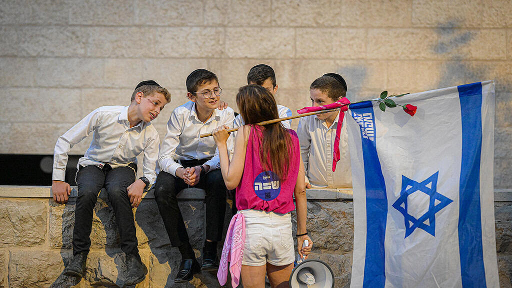 מפגינה עם ילדים חרדים