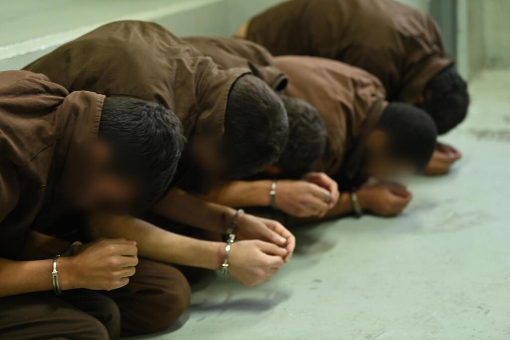 Hamas terrorists captured by Israeli forces during the October 7 cross-border assault are seen handcuffed and detained in an Israeli prison facility (Photo: Israel Prison Service) משטרת ישראל קלטה מחבלי נוחבה מתחילת מלחמת חרבות ברזל