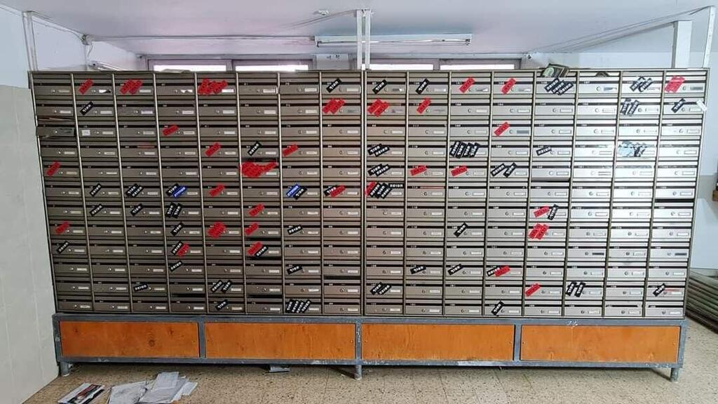 Mailboxes belonging to residents of Kibbutz Nir Oz, marked after the October 7, 2023, Hamas massacre to indicate who was murdered, kidnapped or survived תאי הדואר של חברי קיבוץ ניר עוז: באדום- הנרצחים. בשחור- החטופים