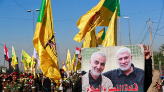 Iraq Iran-backed militias including al-Nujaba and Kataib Hezbollah, march during a funeral in Baghdad for five militants killed in a US strike