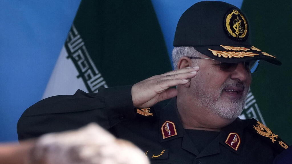 Iranian President Masoud Pezeshkian, right, and  commander of the Revolutionary Guard's ground force Gen. Mohammad Pakpour during a military parade in Tehran 