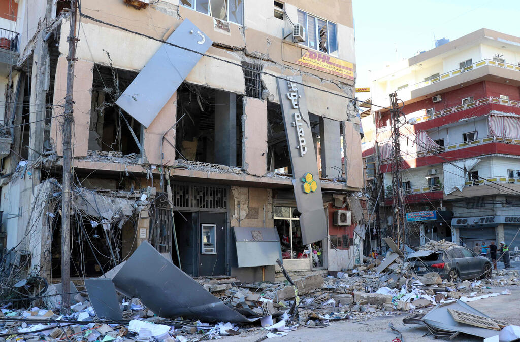 A branch of Al-Qard Al-Hassan financial institution that was attacked in Al-Baqa'a in 2024 (Photo: Bilal Kashmar/ AFP) סניף של אל-קרד אל-חסן בכפר עלי א-נהרי באל-בקאע בלבנון