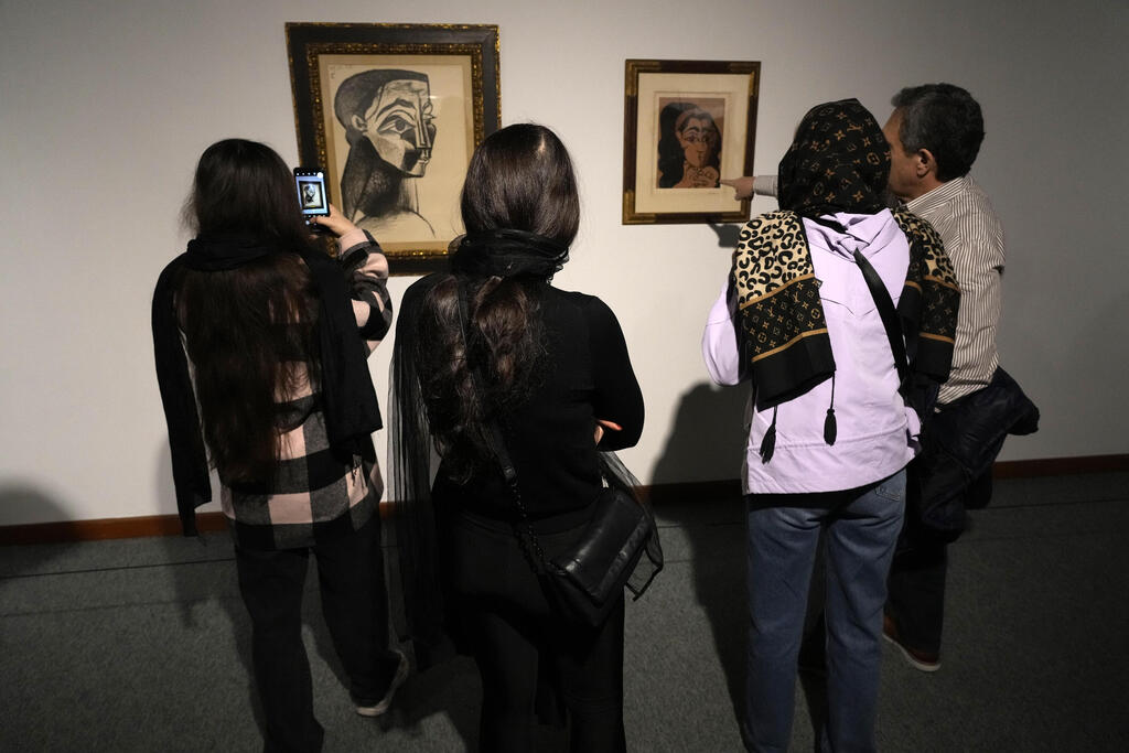 Iranians visit portrait of Rolling Stones Mick Jagger by Andy Warhol at the Eye to Eye exhibition (Vahid Salemi / AP) Iranians visit portrait of Rolling Stones Mick Jagger by Andy Warhol at the Eye to Eye exhibition