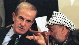PLO Chairman Yasser Arafat (R) and Syrian President Hafez Assad, Sept. 1, 1989 in Tripoli, Libya during ceremonies for the 20th anniversary of the Libyan revolution 