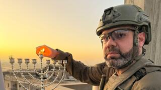 Moshiko Moskowitz lights a Hanukkah candle in Jabalia, Gaza