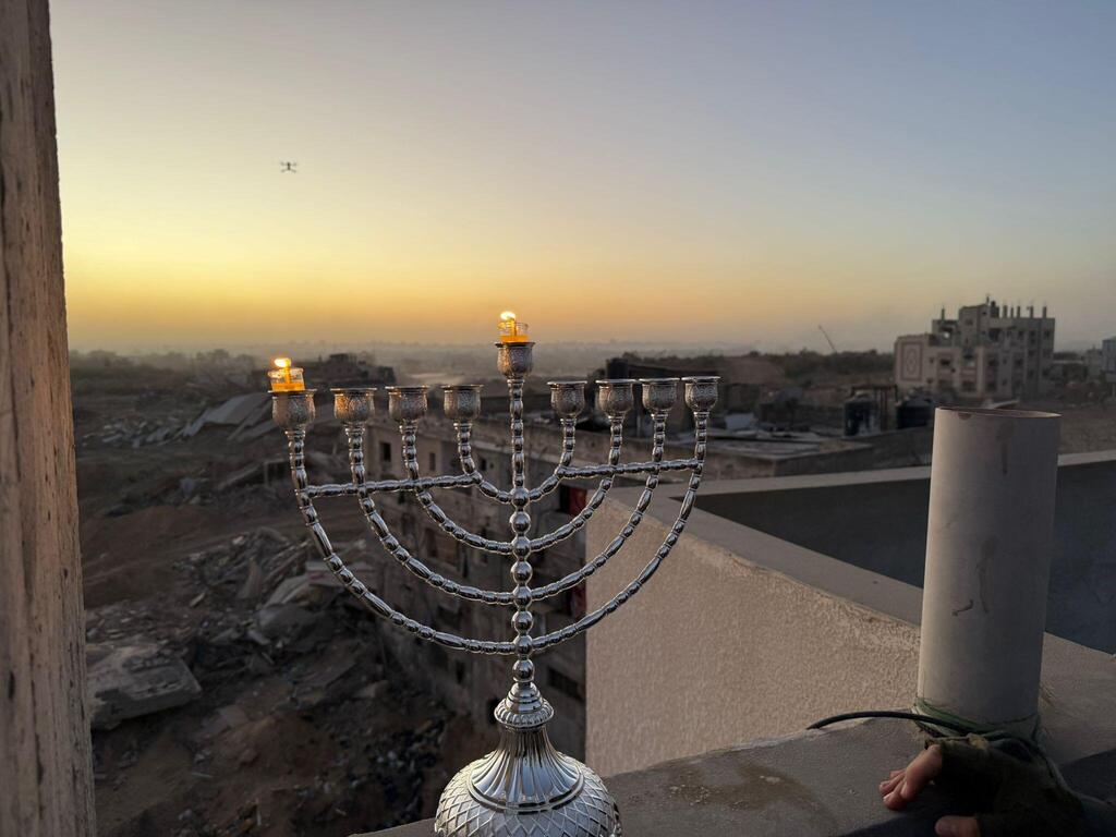 Moshiko Moskowitz lights a Hanukkah candle in Jabalia, Gaza (Courtesy) Moshiko Moskowitz lights a Hanukkah candle in Jabalia, Gaza
