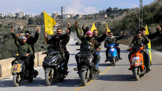 נוסעים עם דגלי חיזבאללה בדרום לבנון באזור כפר כילא