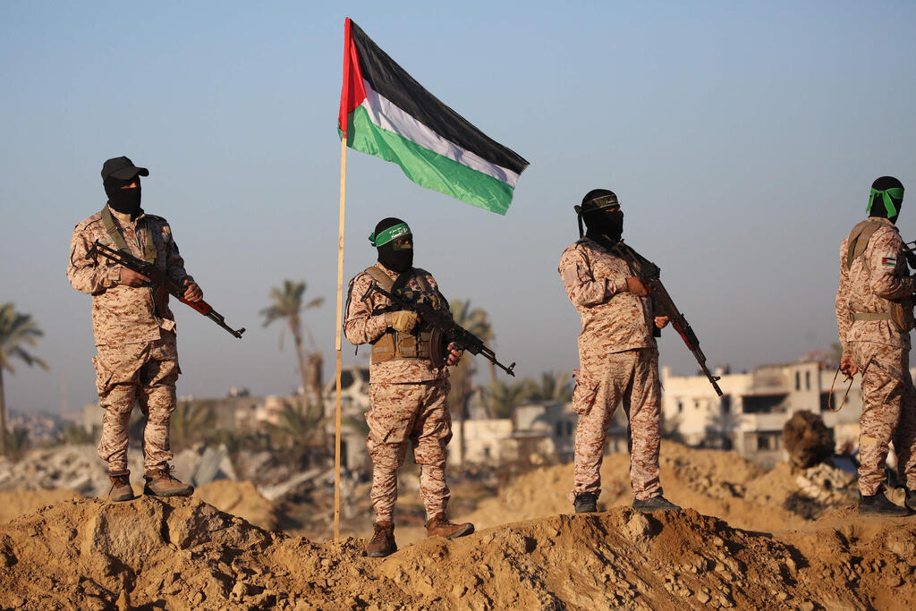 Armed Hamas operatives in Khan Younis, Gaza (Photo: Bashar TALEB / AFP) הבמה בחאן יונס לקראת העברת החטופים