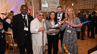 Okotch Mondoh, Robert Weinger, Sarah Boulos, Rory Kaye and Stephanie Bahn Poteet, with a red, white and blue shofar, at the Jerusalem Prayer Breakfast, Mar-a-Lago, Palm Beach, Florida, Jan. 14, 2025 