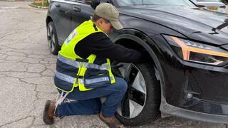 Shilo, a volunteer with Yedidim, helps the author with his shredded tire