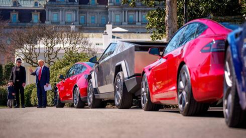 רכבי טסלה באירוע של החברה בבית הלבן, כשברקע טראמפ ומאסק