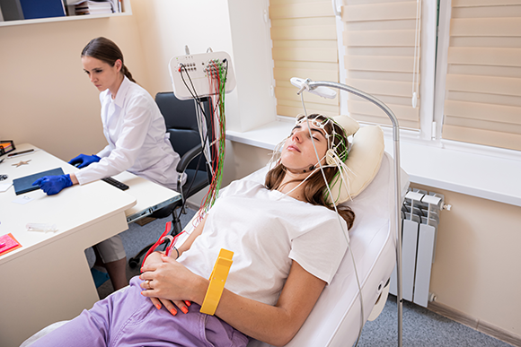 A doctor monitoring a patient’s brain activity using EEG