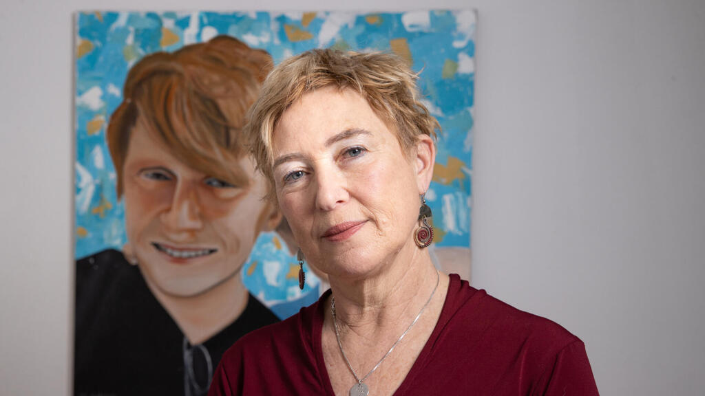 Iris Haim and a portrait of her son Yotam 