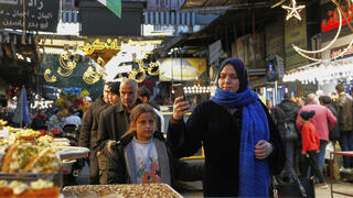Syrians look for sweets to buy during Ramadan, the holy month for Muslims, in Damascus, Syria