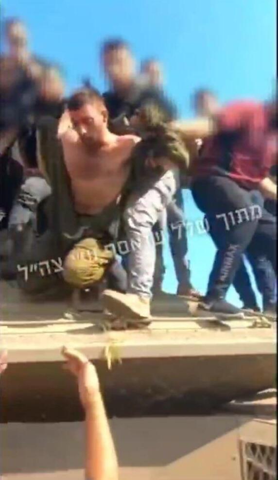 Matan Angrest seen being pulled from his tank by terrorists on October 7, 2023