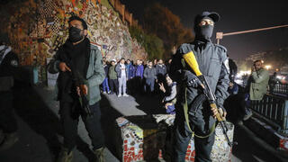 Security forces of the new Syrian government secure the area around group of Alawite protesters in the Mazzeh district in Damascus 