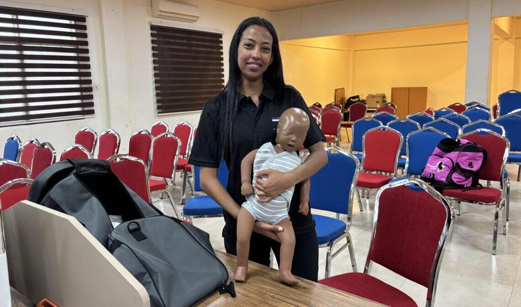 Heaven David of Neonatologists for Africa shows the brown mannequin used by the team (Photo: Maayan Hoffman/The Media Line) Heaven David of Neonatologists for Africa shows the brown mannequin used by the team