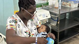 A Ghanaian mother comforts her sick baby 