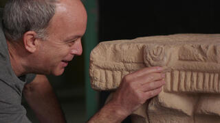 ד"ר עוזי עד, מנהל החפירה, עם כותרת האבן הנדירה