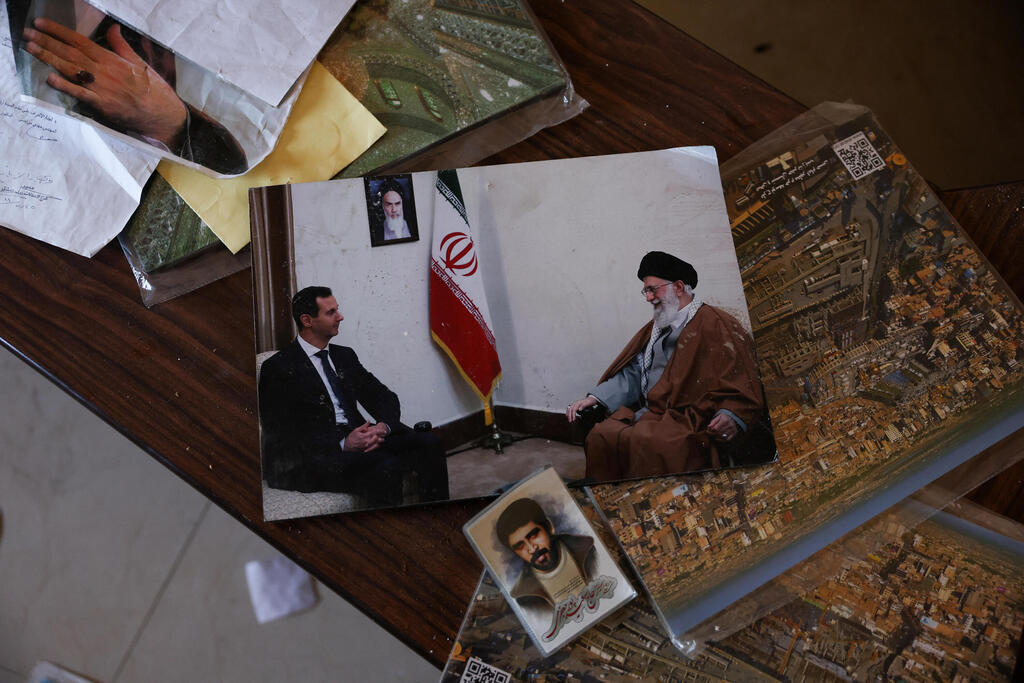 A picture showing former Syrian President Bashar al-Assad meeting with Iran's Supreme Leader Ayatollah Ali Khamenei lies at a hotel used by Iranians in Damascus during the Assad regime 
