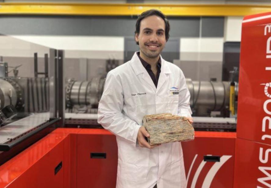 One of the oldest known rock deposits lies in the Jack Hills of Western Australia, containing crystals of the mineral zircon. A researcher holds a rock sample from the Jack Hills