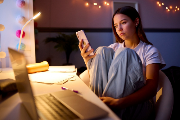 A teenage girl scrolling on her phone 