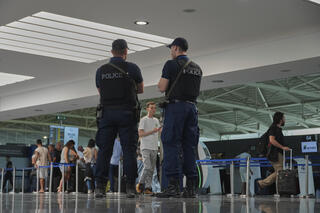 Armed Cypriot police patrol the public areas of the departure lounge of Cyprus' main Larnaca airport 