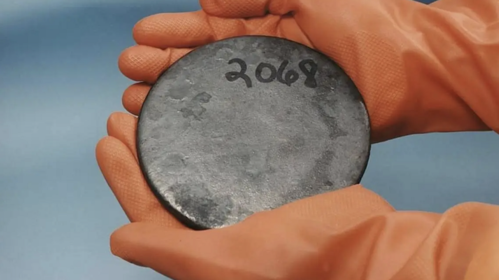The last element on the periodic table, found naturally in large quantities — and more importantly, a fissile one. A disc of enriched metallic uranium 