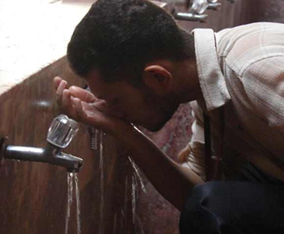 A man rinsing his nose