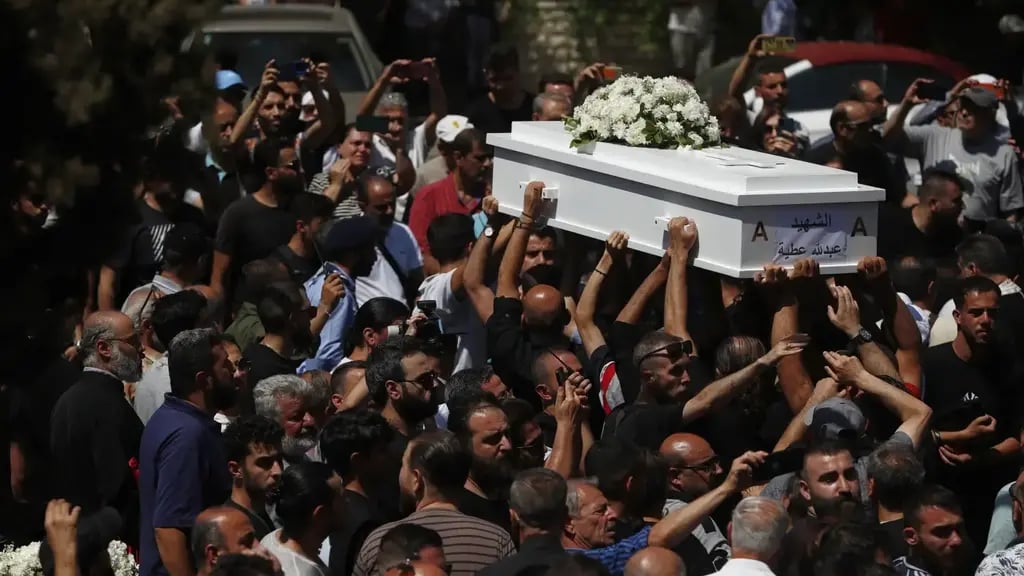 Mourners carry the coffin of a victim of the June 22 suicide bombing at Mar Elias Church during a funeral service at al-Saleeb Church in the al-Qasaa neighborhood of Damascus, Syria 