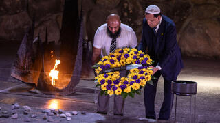 French Imam Hassen Chalghoumi (R) and English Imam Dahri Nour Mouhammad, part of a delegation of Imams and Muslim community leaders from France, Belgium, the Netherlands, Italy and the United Kingdom, attend a memorial ceremony at the Yad Vashem Holocaust Memorial Museum in Jerusalem, on July 8, 2025 