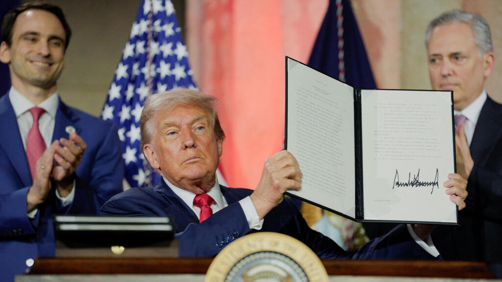 President Trump shows the order he signed at last year’s presentation of the administration’s AI plan (Photo: Reuters) טראמפ מציג את הצו עליו חתם באירוע הצגת תוכנית ה-AI של הממשל